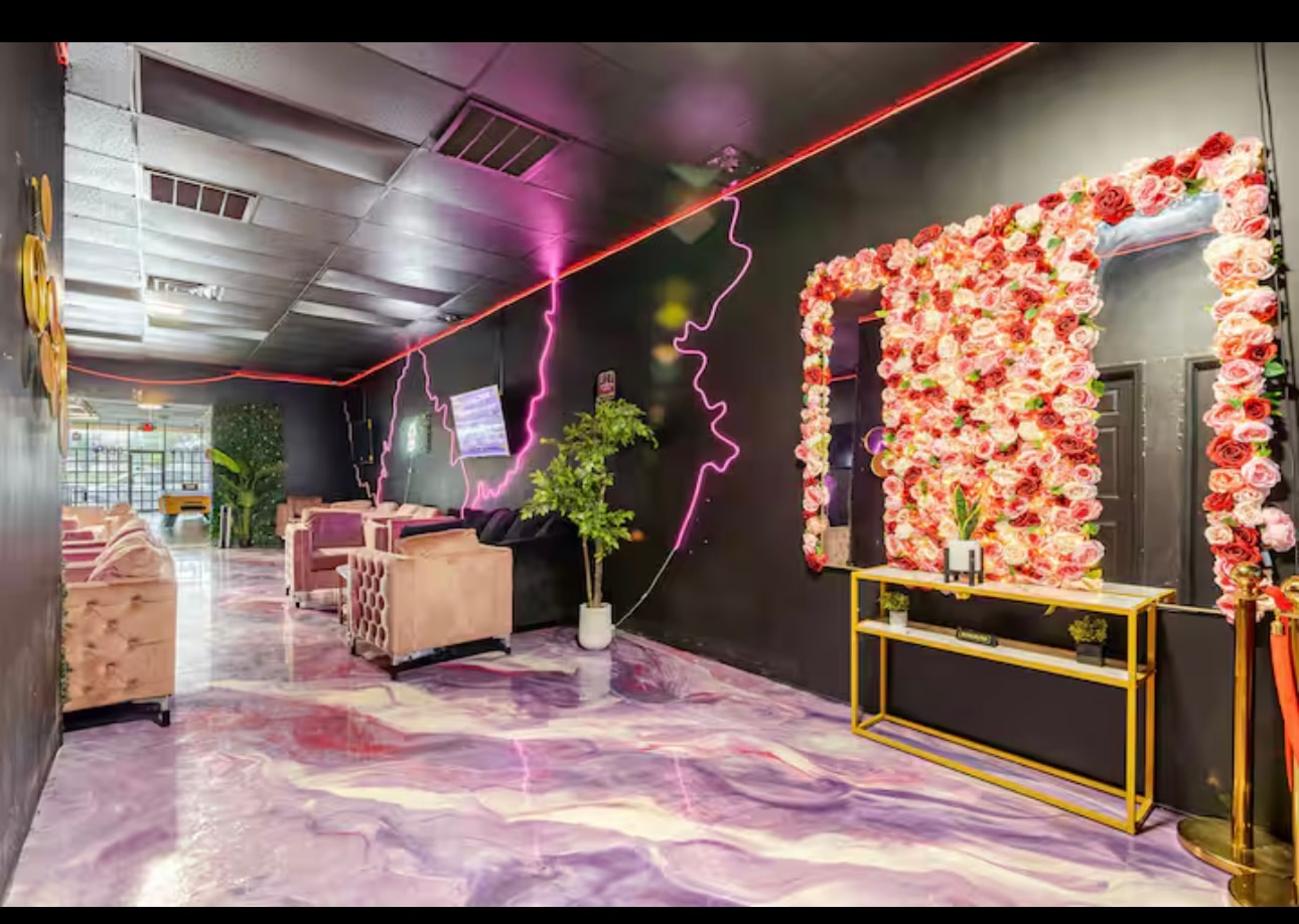 The flower wall at the back of the lounge, beside a gold console table.